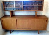 Fabulous vintage teak FAARUP MOBELFABRIK Danish Credenza with three sliding doors and two pull out shelves. This unit is marked "Made in Denmark and Farrup Mobelfavrik." As a bonus, a hutch unit sits on top of the credenza and includes glass sliding doors and shelves. This piece has received a lot of attention nationwide. This is a unique find and in great condition!