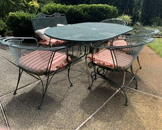 Wrought iron oval table 4 chairs and love seat glider.