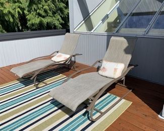Two Lounge chairs and outdoor rug.
