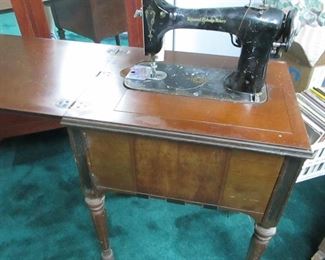 vintage electric sewing machine in cabinet