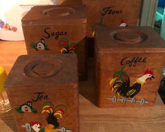 vintage kitchen canisters made of wood depicting a rooster in various yoga poses