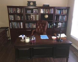VIEW OF FORMER CEO OF AUTOMOTIVE SUPPLIER MAHOGANY DESK, MAHOGANY BOOKCASES AND LEATHER PILLOW TUFTED ARM CHAIR