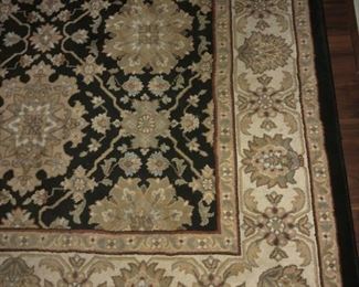 CLOSER UP FRONT VIEW OF HIGH QUALITY PERSIAN STYLE WOOL RUG WITH 3 DESIGN BORDERS