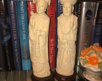 CLOSE UP VIEW OF A PAIR OF CHINESE MAN & WOMAN TALL CARVINGS ON WOOD PEDESTALS