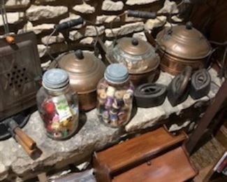 many silver top, blue ball jars.....copper pots, and antique irons.  