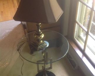 Round glass topped side table with metal base..measures 20" round and 26" high