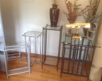 Variety of metal and glass tables and plant stands