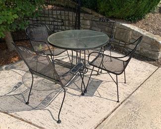 Outdoor patio set with 4 chairs and round glass top table