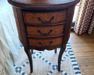 Grab this Rattan and wood side table perfect for any room anywhere. The 3 drawers are great for storage.