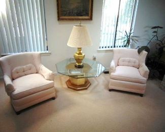 Pair of upholstered arm chairs (sold as a pair), brass table base with octagonal, beveled glass top and a brass lamp