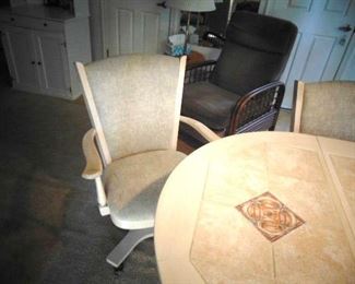 Detail of one of the kitchen table chairs, with arms and is on wheels