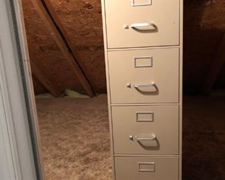 Tall metal filing cabinet. In walk in attic. Upstairs.
