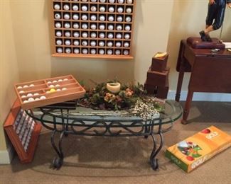 More golf balls and a lovely glass top iron based table