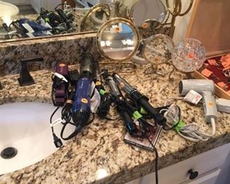 Lots of ladies beauty items: vanity mirrors, curling irons, blow dryers and more!