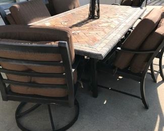 Rectangular Patio table with natural Mosaic Slate top (1.6" thick) and Iron framework. Includes 6 chairs with cushions and umbrella 