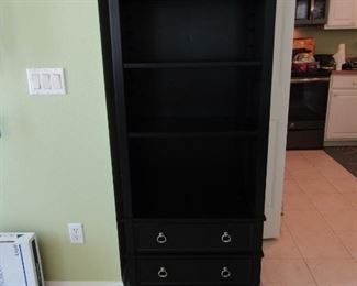 A BLACK DISPLAY UNIT WITH 2 DRAWERS FRO STORAGE