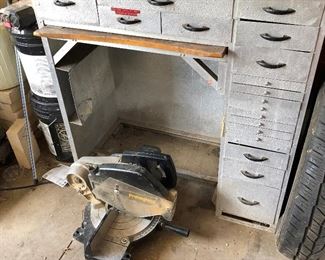 Old metal desk with many small drawers.