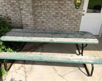 Picnic table, weathered, but sturdy.