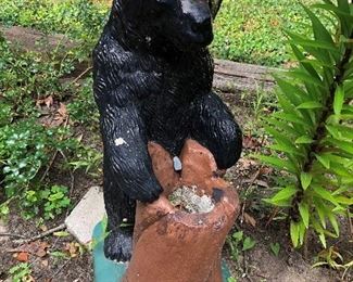 Concrete sculpture of black bear.