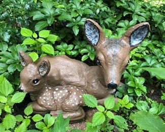 Concrete sculpture of whitetail doe with fawn.