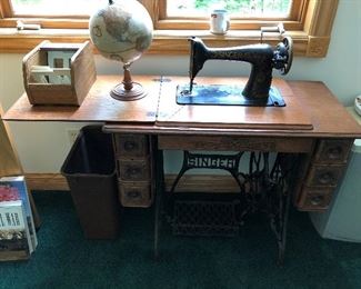 Antique Singer sewing machine w/cabinet; globe of Earth.