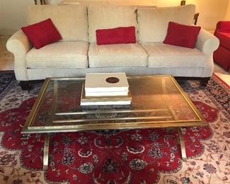 THREE CUSHION SOFA MID-CENTURY MODERN OFF WHITE/ BRASS AND GLASS COFFEE TABLE/ RED CENTER RUG