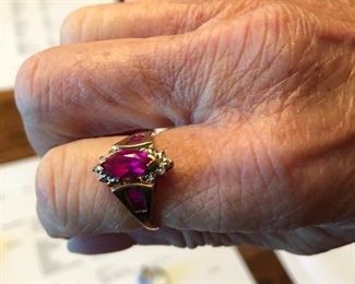 This 10k yellow gold Ruby and diamond ring 1.32 Marquis mounted ruby has 4 faceted mounted Ruby’s 2 on each side with 2 single cut .01 ct diamonds