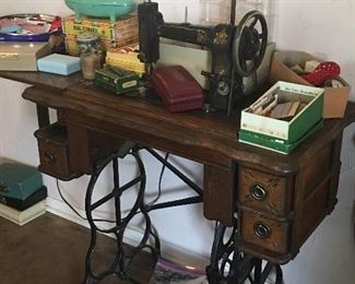 vintage peddle sewing machine in cabinet