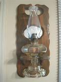 Oil lamp on wall frame