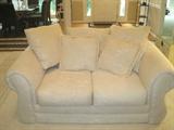 Lovely white upholstered love seat/ 5 pillows