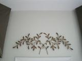 Metal brass leaf wall décor above den door