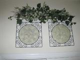 Pair of wall décor with greenery above door