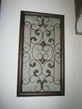 Wrought iron frame with green fabric panel behind metal openwork - wall art decor