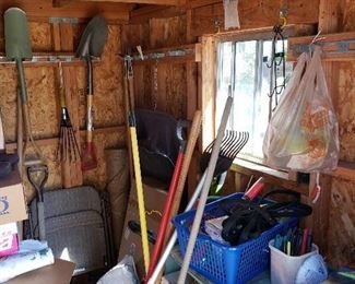 Plenty of shovels, rakes, and other yard tools.