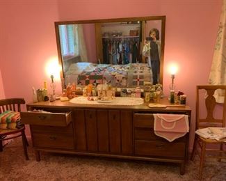dresser with mirror and large amount of vintage Avon bottles. Sweet side chairs
