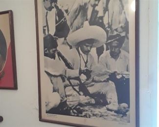 Photo of young man with others gathered around.