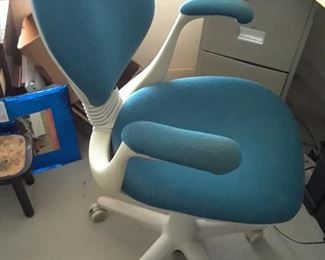 Turquoise ergonomic chair with white frame is unusual