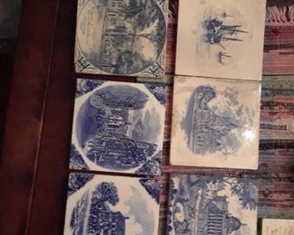 Tiles by Mintons, Wedgwood. Six blue and white, one sepia on ivory ground.