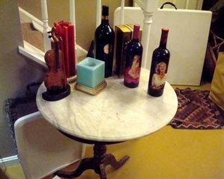 Round marble top table and other items including Norma Jean bottles.