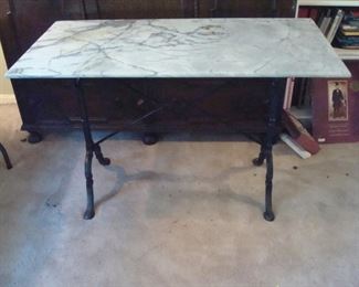 Cast iron base marble top table.