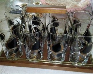 Vintage decorated barware in carry caddy.