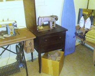 Two sewing machines and a collection of antique shoe-cobbling forms. 