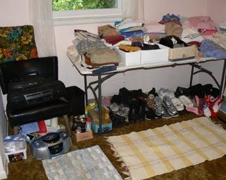 Vintage black vinyl-covered accent chair and assorted clothing and linens.