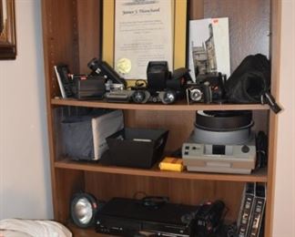 Argus, Samsung, Poloraid Cameras, Bell Howell Slide Projector, Cameras, Pan Vue, Kodak Slide Projector Viewer Fuji Camera, Award from Gov. Blanchard, Schneider Krutzbach Cameras, Focal Binoculars