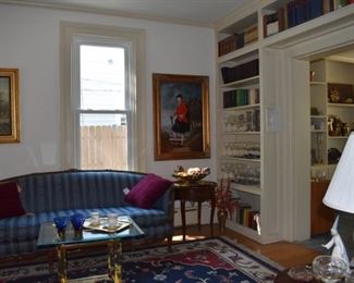 Other side of Parlor Overview, Lovely Sofa, Brass Table with Beveled Glass Top, Statue of Rebecca, Stemware, Books, Lamp, Lladro, Glassware, Vases