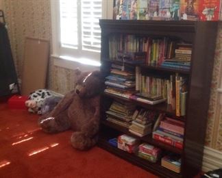 4 shelf wood bookcase filled with games & books