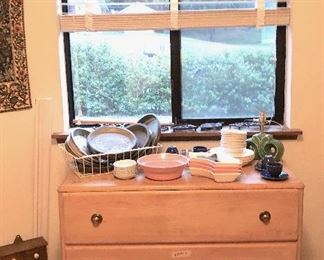 Vintage pie tins and a light maple dresser