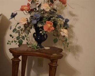 Side table (one of a matching pair) with floral arrangement. 