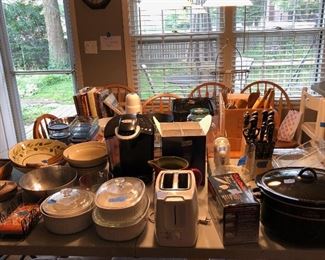 Kitchen items - many items of high quality, including:  Keurig coffee maker, Pottery Barn plates, Bennington Vermont trigger mugs, lots of Crate & Barrel serving items, toaster, knife set, flatware, serving and baking bowls and dishes, crock pot, roasting pans, storage containers, etc.