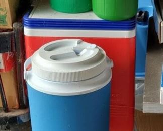 LOTS of jugs and coolers of various shapes, sizes and colors.